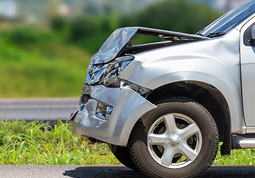 Automobile-Insurance-Guide-Thumb silver car front end damage from collision