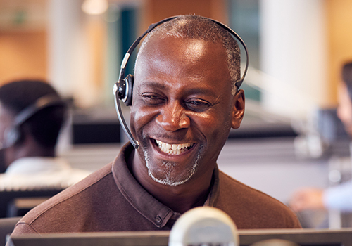 smiling customer service representative on phone headset