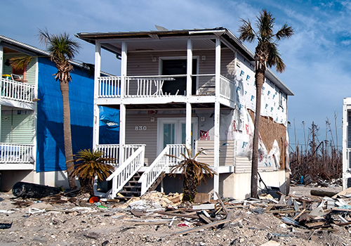 two-story home damaged by hurricane