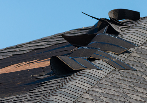 Roof damage exposed shingles