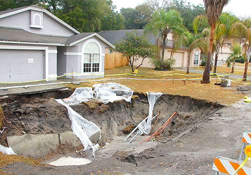 large sinkhole in front of residential property
