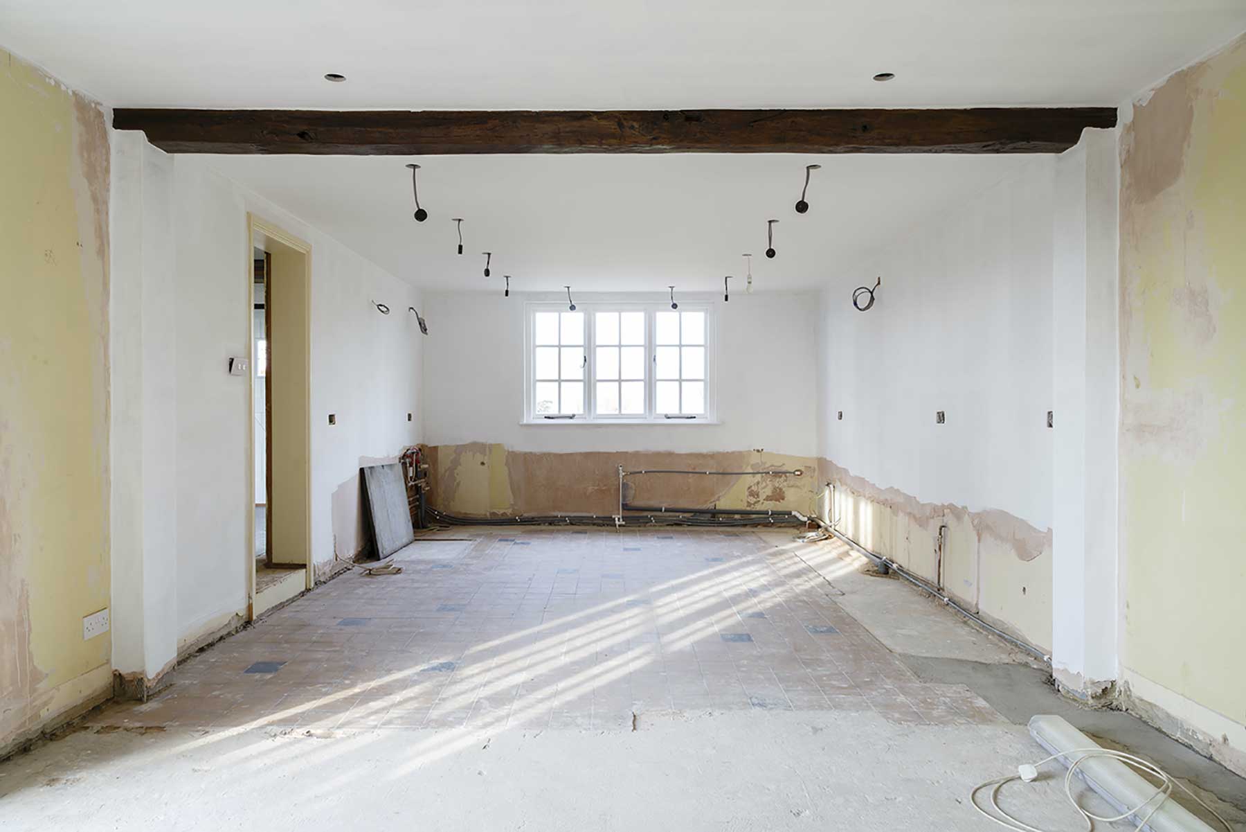 Example of a gutted home - kitchen with no appliances, cabinets or flooring