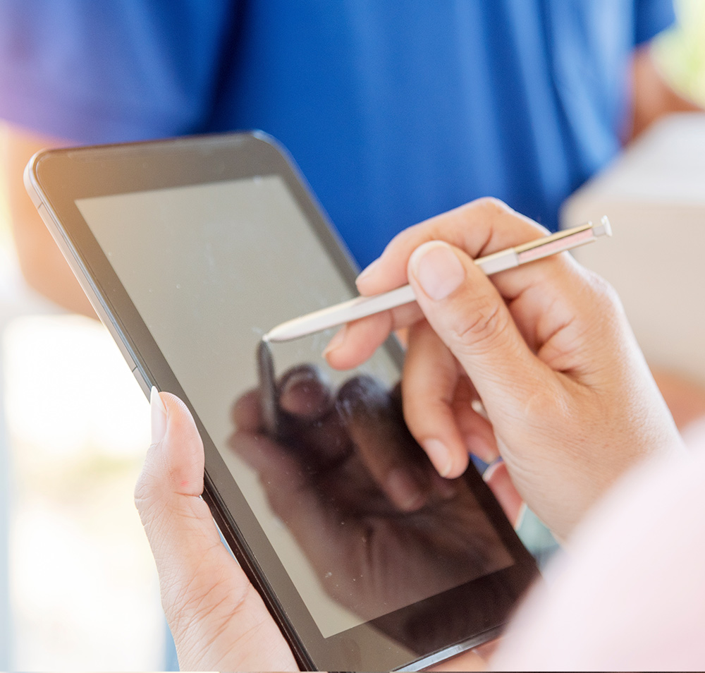 Woman signing electronically on a tablet