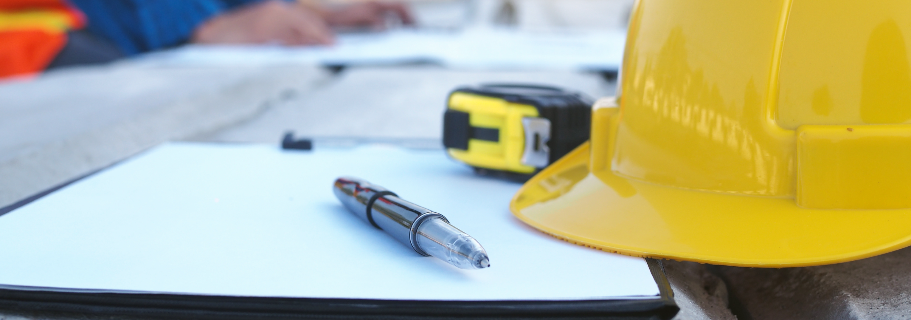 construction hard hat, plans and measuring tape