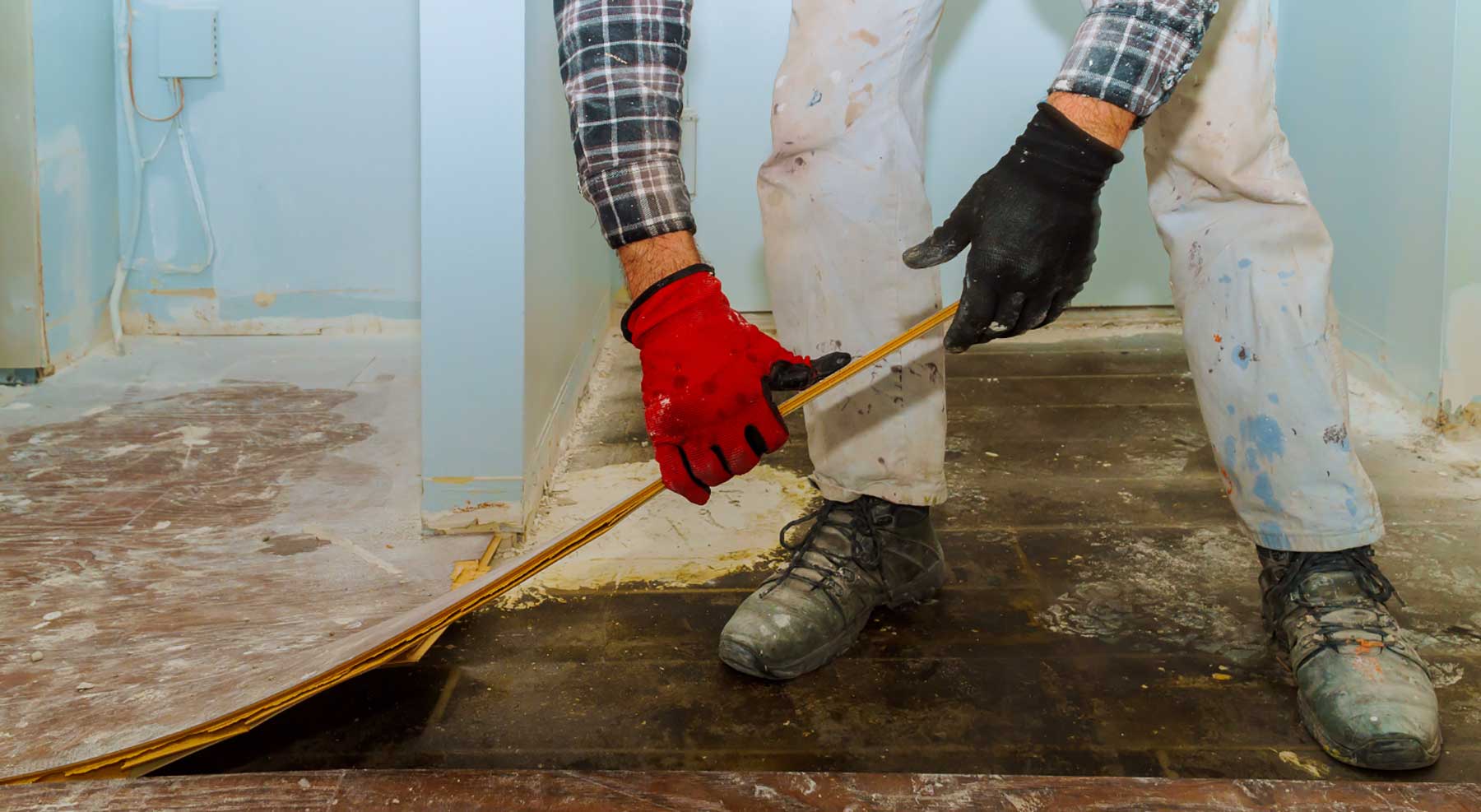 Man pulling up floors