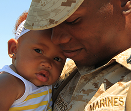 African-American soldier in uniform with baby daughter