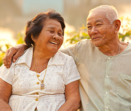 Asian Older couple outside smiling