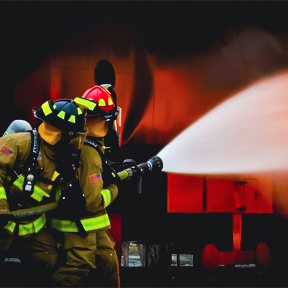 Firefighter spraying from firehose