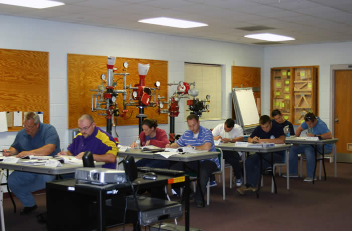 Students in classroom taking an exam Students in classroom taking an exam